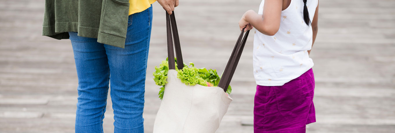 Mother and daughter carrying a grocery bag. Gluten-free, non-GMO, kosher and sustainability are QAI certifications your family cares about.