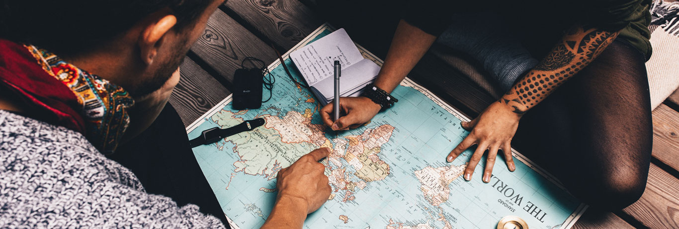 Two people studying a map. Find your way using QAI’s map for certification.