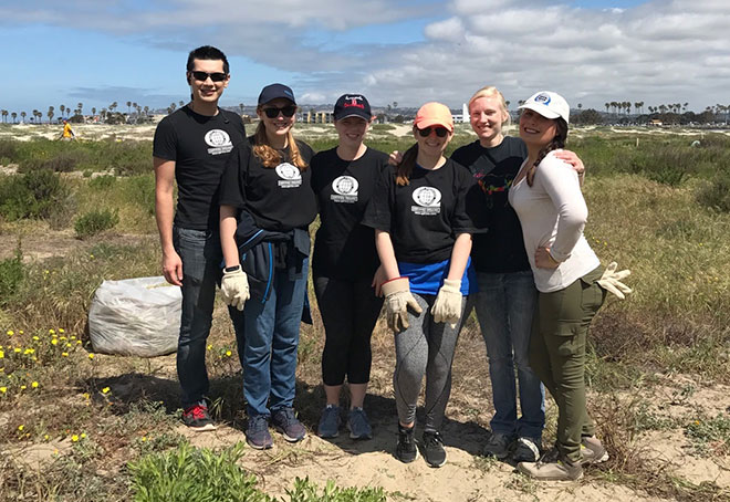 QAI organic certification team volunteers at beach clean-up.