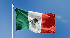 Mexican flag against blue sky